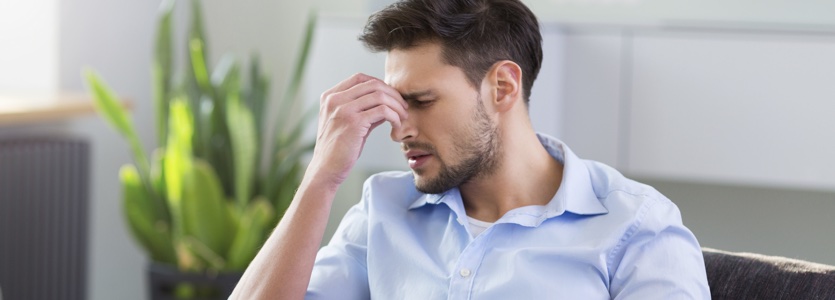 Man On Sofa Having Headache man